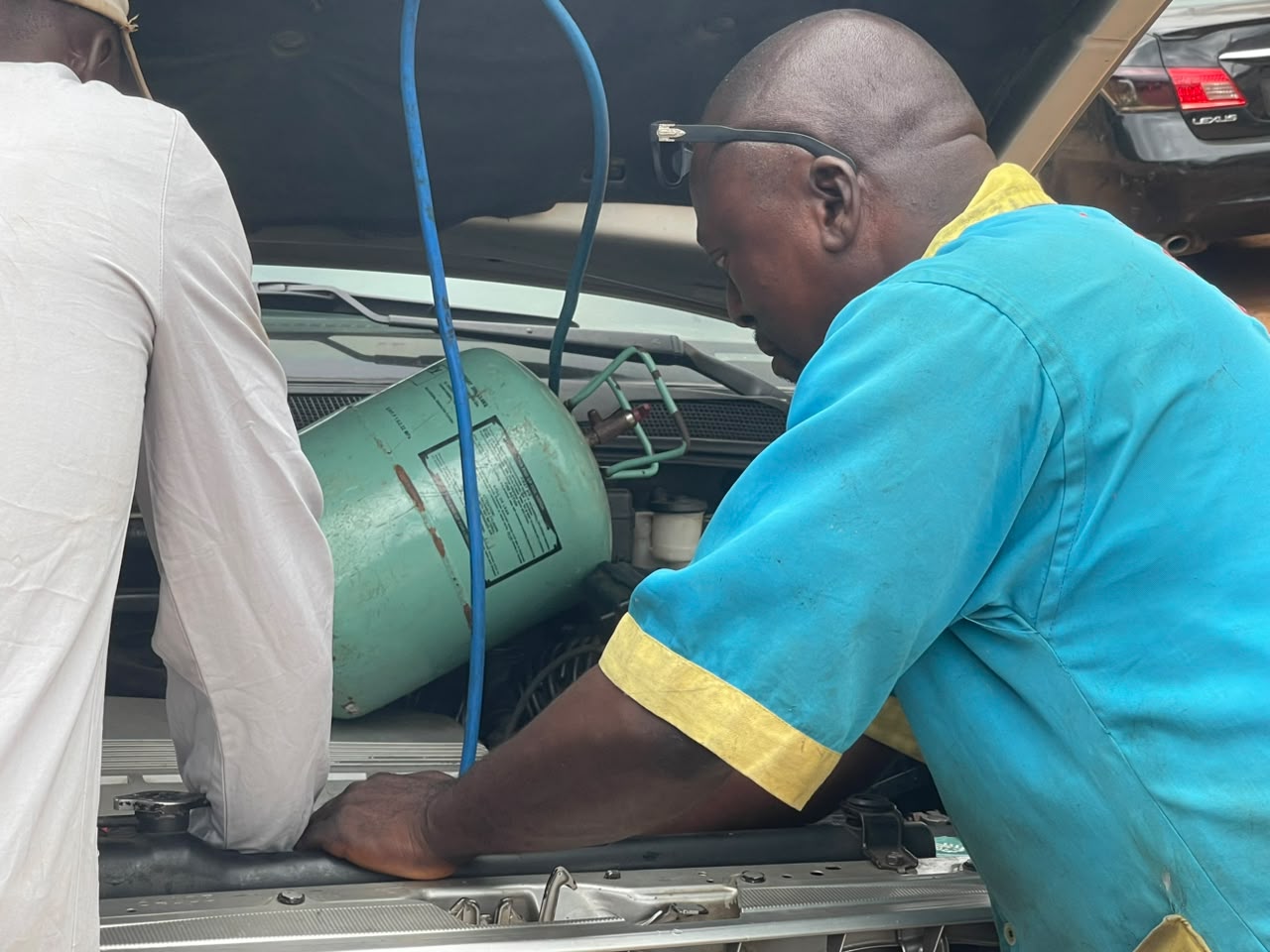 Automotive engineer working under the bonnet of a vehicle